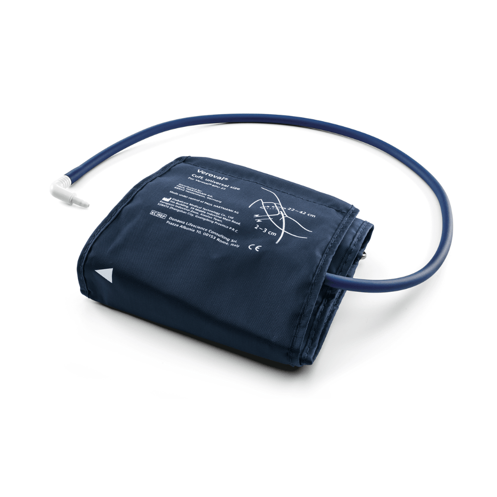 A Hartmann Veroval® Compact upper arm blood pressure monitor by Paul Hartmann AG with a blue nylon cover and attached rubber hose, laid out on a white background, with printed instructions visible on the cover.