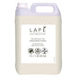 A white 5-liter plastic canister of LAPĒ Collection Oriental Lemon Tea Hand & Body Lotion by Diversey Germany with an oriental scent. With natural ingredients, cruelty-free and vegan certification, and a bright lemon label.