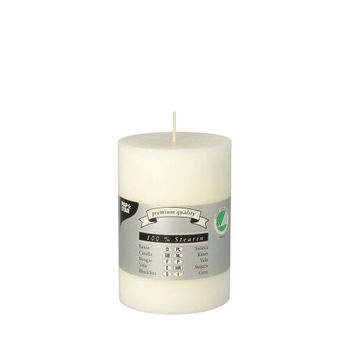 The PAPSTAR pillar candle (Ø 70 mm, 100 mm) from PAPSTAR GmbH is a white, dyed candle with a wick, a gray multilingual label with a green certification logo, made of 100% stearin. Monochrome white background.
