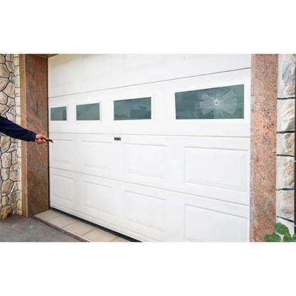 A person points to a white garage door with four rectangular windows, one of which is broken in a spider web pattern - ideal for repair with 3M Deutschland GmbH Scotch® Extremium™ INVISIBLE High-Performance Tape (20 m x 48 mm). Stone and tiles border the garage.