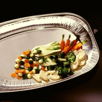 An oval Starpak 10 serving platter made of aluminum by Starpak presents a colorful selection of steamed baby carrots, broccoli, cauliflower, zucchini, and beets – ideal for buffets and catering or wedding celebrations against a dark background.