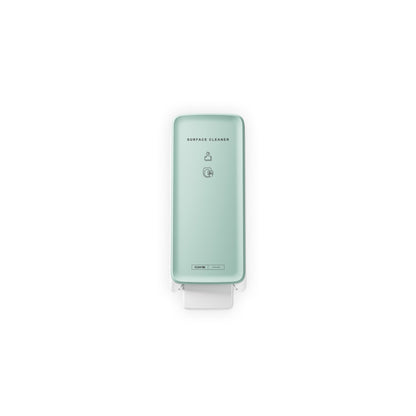 The CWS PureLine front panel for the surface cleaner toilet by CWS is a light green, wall-mounted dispenser with modern design, a push lever at the bottom, and simple black lettering/symbols that stand out against a plain white background.