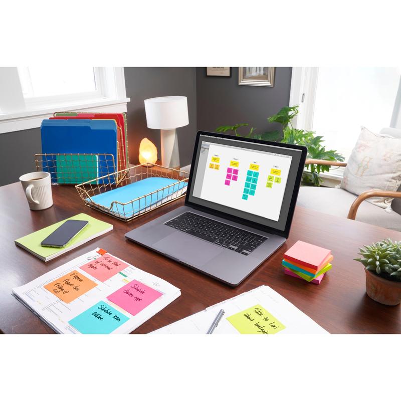 A tidy home office desk with a laptop and digital calendar, colorful folders, smartphone, notebooks, 3M Deutschland GmbH Post-it® Notes Poptimistic Collection (38 mm x 51 mm), pen, small plant, and lamp in bright daylight.