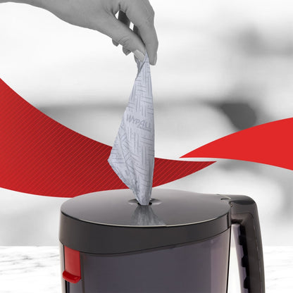 A hand pulls a WypAll® Reach™ paper towel for food & hygiene - centerfeed from Kimberly-Clark GmbH out of a gray canister, promoting hygiene. Red, curved lines are visible in the background.