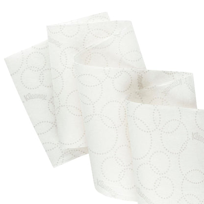 Close-up of a white Kleenex® Ultra™ Slimroll™ hand towel roll from Kimberly-Clark GmbH with a subtle dot pattern and partial unrolling to show its suitability for narrow dispensing systems; 6 rolls per carton.