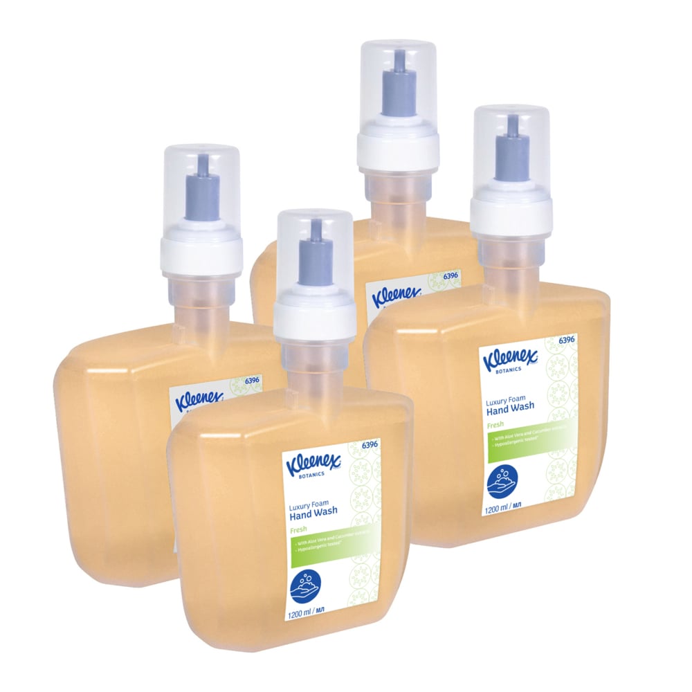 Four 1.2-liter Kleenex® Botanics™ Luxury Foam Hand Wash cassettes from Kimberly-Clark GmbH, each with a pump and white/blue labels, filled with orange foam hand soap, are grouped together. The package contains 4 electronic cartridges per box.