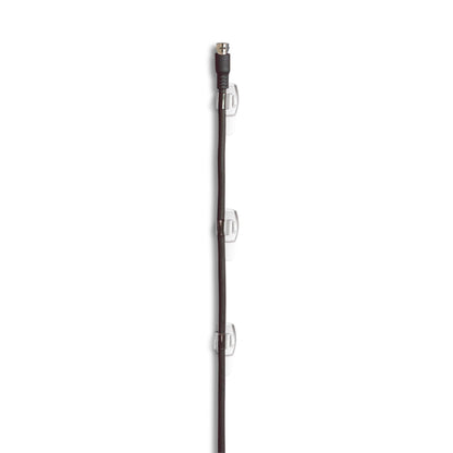 A black coaxial cable is vertically attached to a white wall with three Command™ transparent clips for round cables, 17017CLR from 3M Deutschland GmbH, with each clip serving as a secure cable holder and evenly distributed along the cable.