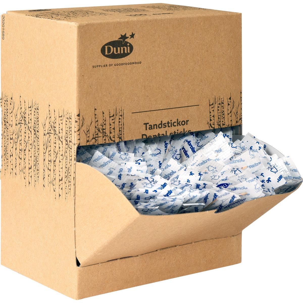 Tá bosca dearthóra donn déanta as cairtchlár a bhfuil an téacs "Duni GmbH Zahnstocher Neutral Holz 50 | Packung (1000 Stück)" air agus tá sé lán de phiocáin fhiacla adhmaid aonair pacáilte i bpacáistiú bán agus gorm, agus tá cuid acu le feiceáil tríd an gclúdach tosaigh oscailte.