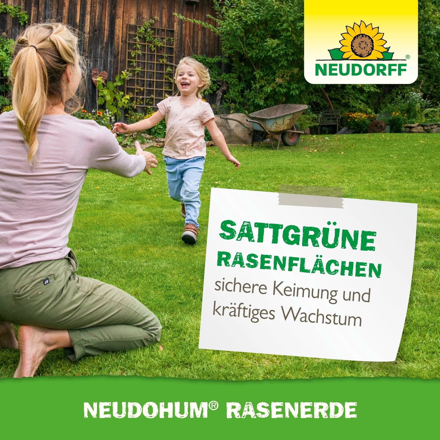 A woman kneels with outstretched arms in the green grass while a child runs smiling towards her. Background: wooden building, shrubs. Text advertises NeudoHum Lawn Soil from Neudorff Shop for a greener lawn and healthy lawn area.