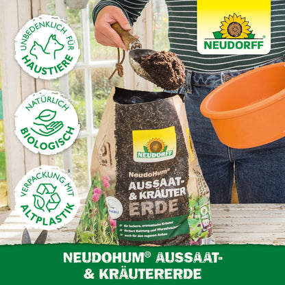 A person fills an orange pot with NeudoHum Seed & Herb Soil from Neudorff Shop - a biological, pet-friendly seed and herb soil in a bioplastic package, ideal for Mediterranean herbs.