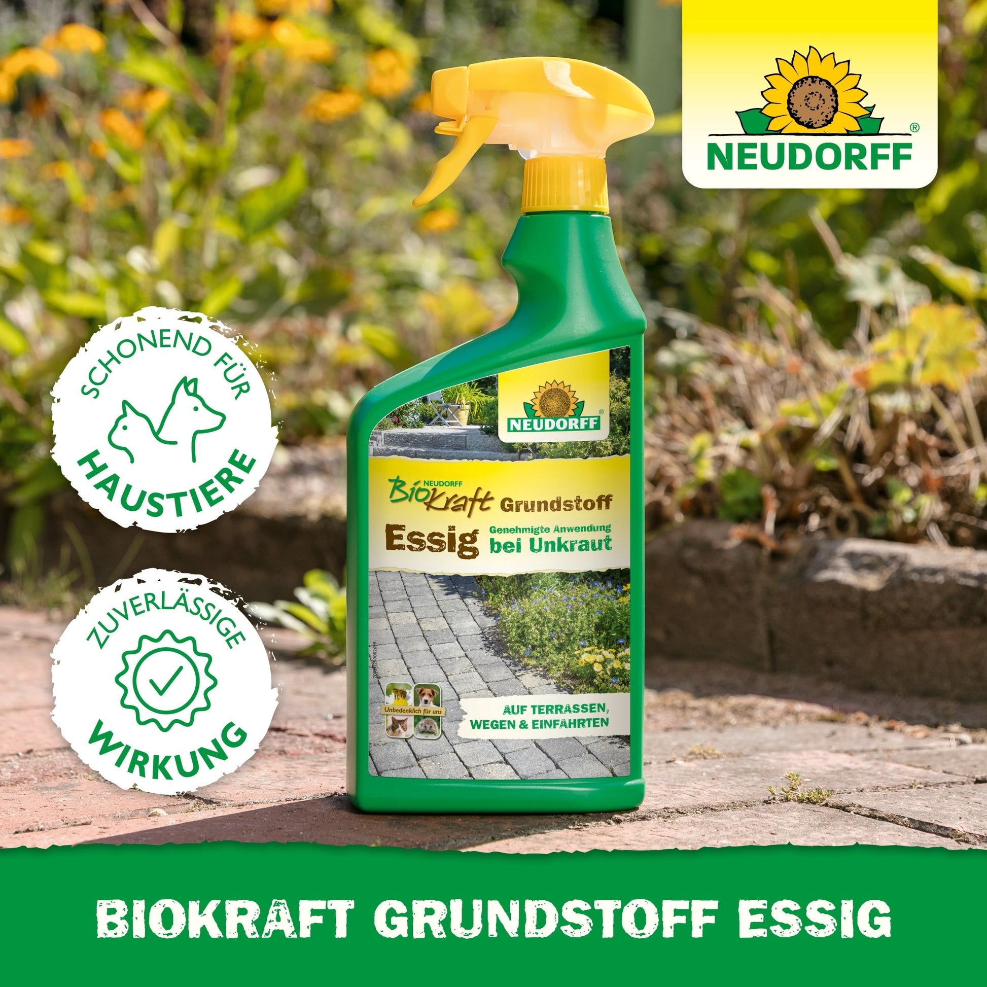 A spray bottle with Neudorff BioKraft Base Material Vinegar from the Neudorff Shop stands on a garden path, surrounded by grass and flowers. The label emphasizes pet safety and effective weed removal for clean terraces.