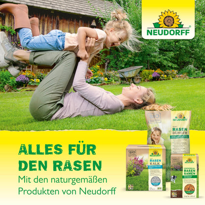 A woman on a grassy lawn lifts a smiling child above her. In the foreground, Neudorff's UrgesteinsMehl from the Neudorff Shop is visible. The text reads: "Everything for the lawn. With Neudorff's natural products.