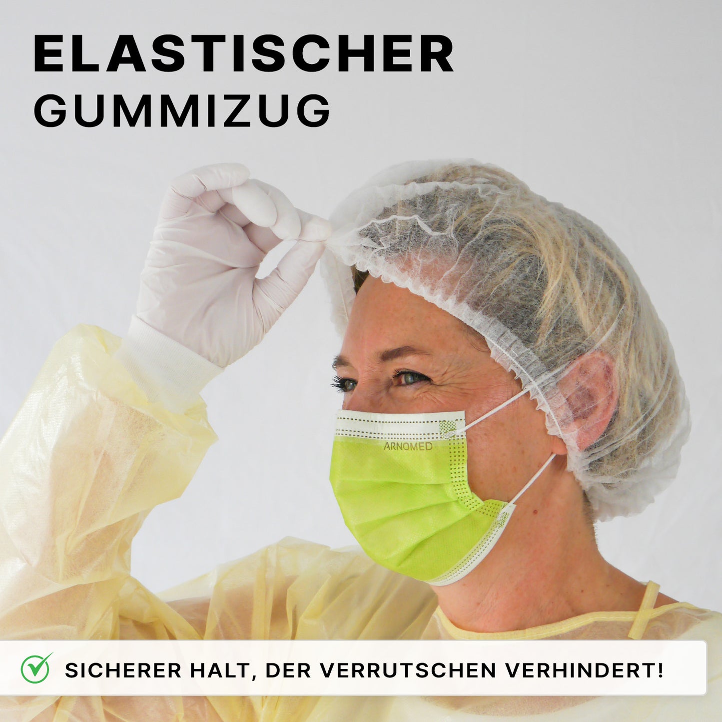 Eine Person mit Einwegkittel, Handschuhen und grüner Maske passt ihre ARNOMED COVER PP-KLIPPHAUBE Einmalklipphaube aus PP-Vlies (52cm, ARNOWA GmbH) an. Text: "Elastischer Gummizug" und "Sicherer Halt, der Verrutschen verhindert!.