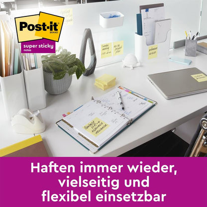 A tidy white desk with a laptop, notebook, and plant, where 3M Deutschland GmbH Post-it® Super Sticky Notes, Yellow (76 mm x 76 mm) are attached. German text: "Stick repeatedly, versatile and flexible to use."