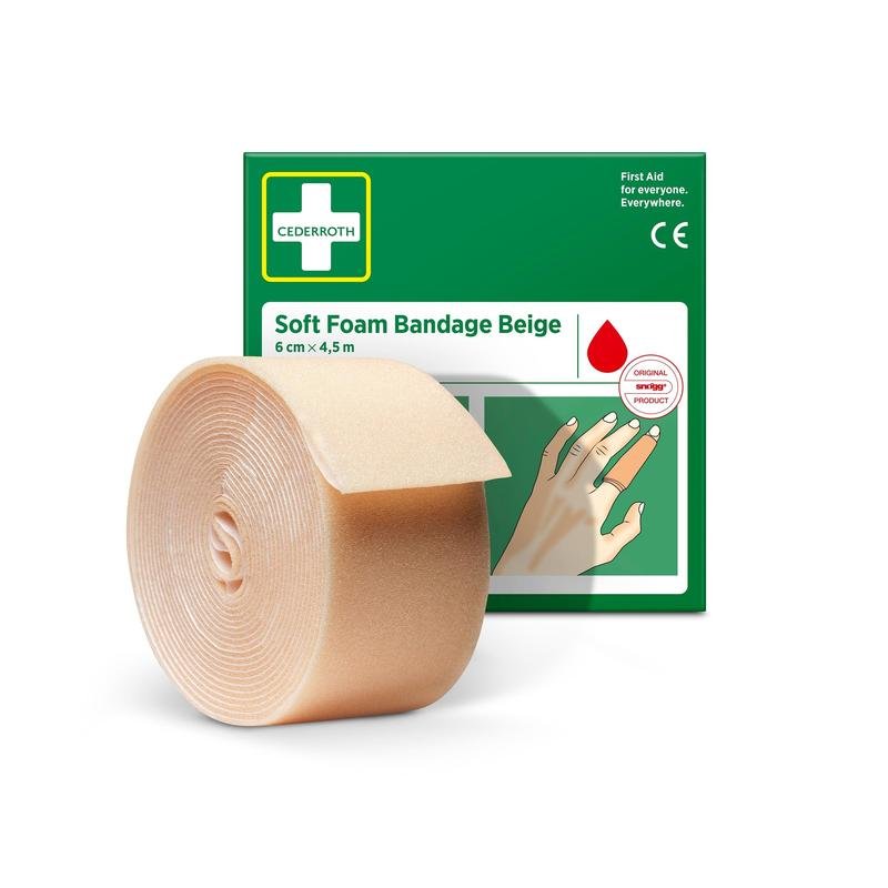 A roll of Cederroth soft foam bandage beige 6 cm x 4.5 m from Orkla Wound Care AB stands in front of the green-white box, which features a hand with a bandaged finger and the product's name.