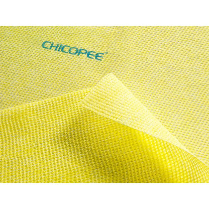 A close-up of a yellow, textured Suma Lavette Medium kitchen hygiene cloth with germ stop from Diversey Deutschland GmbH & Co. OHG, with one corner folded to show both sides - ideal for cleaning and disinfection.