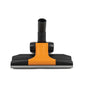 A close-up of the TASKI AERO Combi-Ultra-Flat Nozzle 32mm from Diversey Deutschland GmbH & Co. OHG. It shows the black-orange design, the wheels, and the hose connection, which is compatible with TASKI AERO vacuum cleaners. Package: 1 piece.