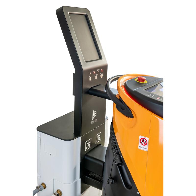 A touchscreen control panel is next to an orange-grey TASKI GS Ecobot 50P with hose, no smoking sticker, and the TASKI GS Service Station 50 from Diversey for combined charging of power and water. (1 pack).
