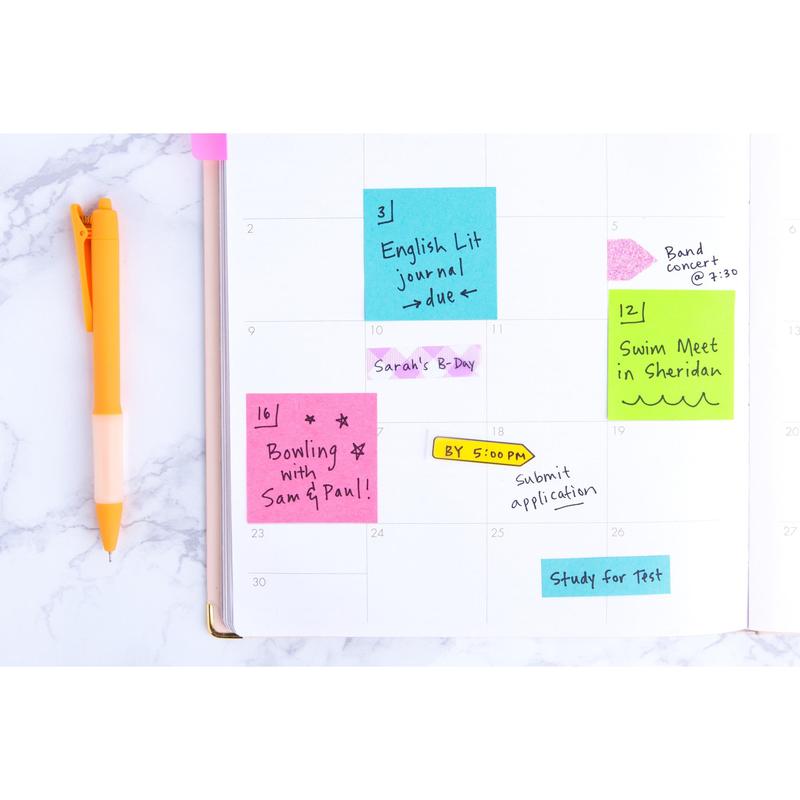 An open planner shows colorful Post-it® Notes from the Poptimistic Collection by 3M Deutschland GmbH, on which appointments and reminders are noted. On the left side lies an orange pen. Each package contains 12 blocks of 100 sheets, made from 100% PEFC-certified paper.