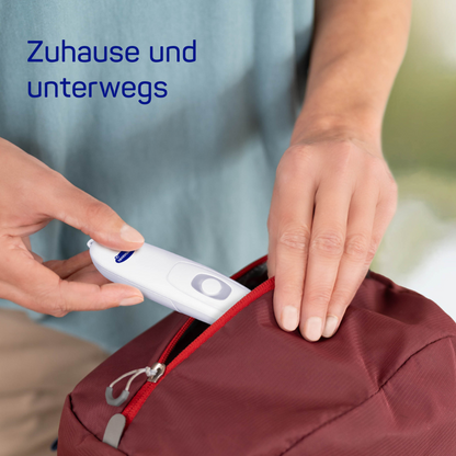 A person uses a HARTMANN insect bite healer | Pack (1 piece) by Paul Hartmann AG to disinfect or check a red backpack. The text above reads "at home and on the go."