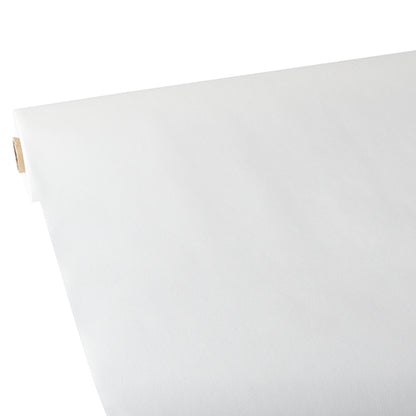 Eine Nahaufnahme einer Rolle Starpak-Tischdecke, stoffähnlich, Vlies „Soft Selection“, teilweise ausgerollt auf einer flachen Oberfläche, wobei der Pappröhrenkern links sichtbar ist.