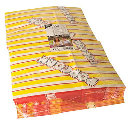 Pictured is a stack of PAPSTAR 100 popcorn bags, yellow-red striped greaseproof parchment substitute bags with the slanted print "POPCORN", with a visible packaging label of PAPSTAR GmbH on top.