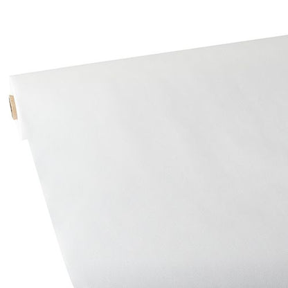 A large roll of Starpak tablecloth, fabric-like, fleece 'Soft Selection' (25 m x 1.18 m, white) is rolled out on a flat surface, with the smooth surface visible at the upward-curved edge. The Starpak roll is seen diagonally from one corner.