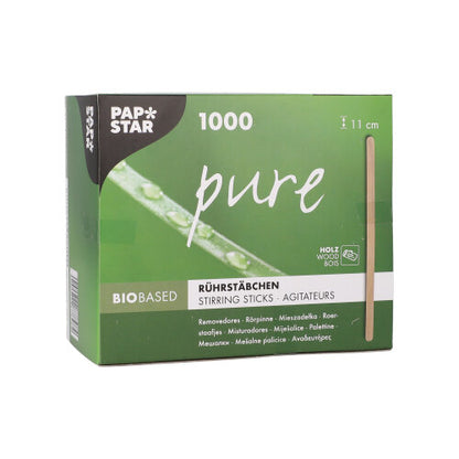 A green-white box from PAPSTAR GmbH with the inscription "pure" contains 1000 environmentally friendly, stable wooden stir sticks (11 cm). The folding box displays product information in several languages as well as a vertical image of a stick.