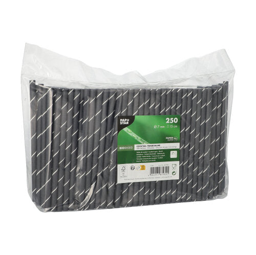 A transparent plastic packaging contains 250 PAPSTAR cocktail straws 7 mm, black/white "Stripes", 15 cm. The label of PAPSTAR GmbH shows product information and eco-friendly symbols.
