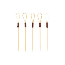 Forty PAPSTAR finger food picks 10 cm "Loop" cocktail picks from PAPSTAR GmbH, ideal for snacks and finger food, feature a unique loop design with dark brown wrapped sections arranged upright against a plain white background.