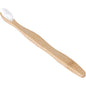 An ENA Living toothbrush made of bamboo and nylon from Abena Re-Seller GmbH lies on a white background; the handle with a wood texture is slightly curved - ideal for eco-friendly dental care. Pack of 30 pieces.