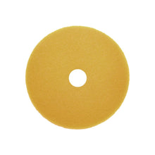 A yellow, circular Arcora Sunshine Fine No3 Block (cardboard, 10 pieces) from Arcora International GmbH with a center hole, viewed from above on a white background - perfect as a cleaning item for commercial cleaning.