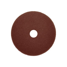 A round, dark brown Arcora Sunshine Strong Plus No1+ Pad by Arcora International GmbH with a textured surface and hole, photographed on a white background. Available in a box (10 pieces).
