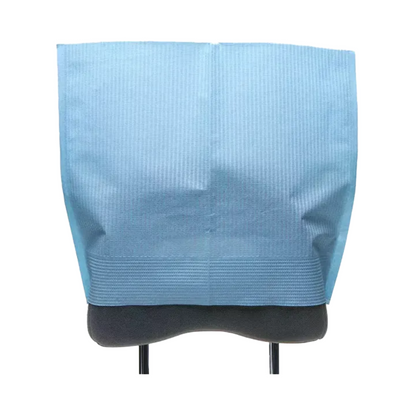 An AMPri Dental headrest cover in light blue is draped over a rectangular object with a black stand against a white background.