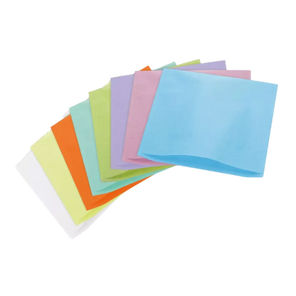 A fan-shaped arrangement of colorful paper napkins in shades of blue, pink, green, orange, yellow, and white, spread out on a white background, reminiscent of the vibrant colors typically found in the tissue wrappers of the AMPri Dental headrest cover by AMPri Handelsgesellschaft mbH.