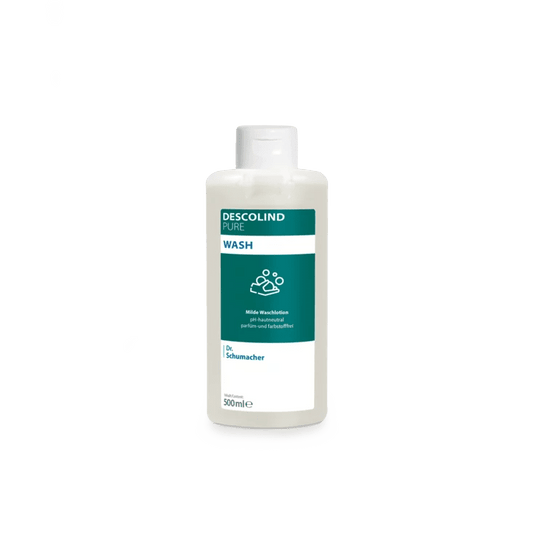 A white plastic bottle of Dr. Schumacher Descolind Pure Wash Cleansing Lotion (500 ml) by Dr. Schumacher GmbH, featuring a green-and-white label, is shown against a plain light gray background. This pH-balanced, fragrance-free cleansing lotion is ideal for sensitive skin.