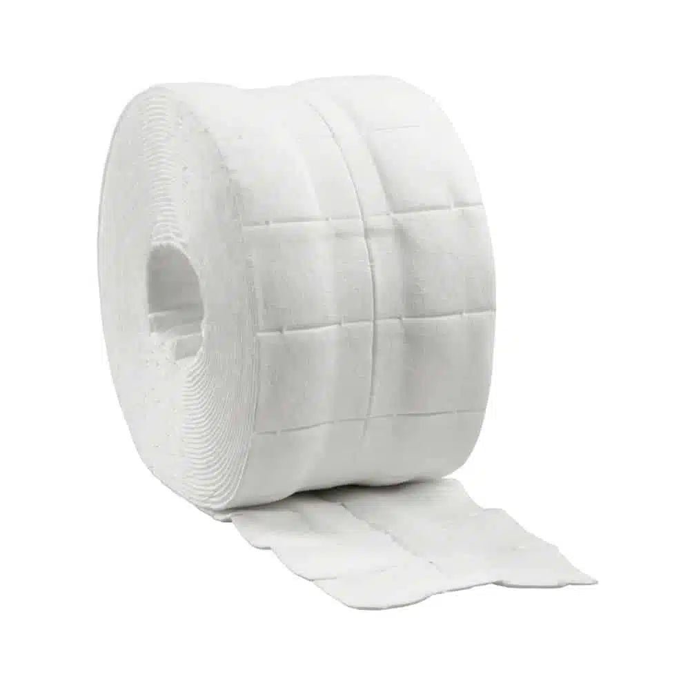 A large roll of white toilet paper with quilted texture, partially unrolled and presented against a white background, reminiscent of the absorbent B. Braun Askina® Brauncel® cellulose swabs used for gentle skin cleansing.