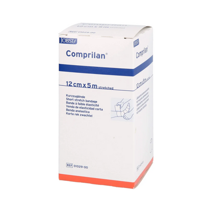 The picture shows a box of BSN Comprilan® elastic bandage, compression bandage, with dimensions of 12 cm x 5 m. The predominantly white packaging has blue and orange accents, as well as text and a small illustration showing the application of the bandage and emphasizing its effectiveness as a compression bandage. This product is from BSN Medical GmbH.