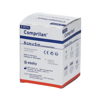 The packaging of the BSN Comprilan® elastic bandage, a compression bandage measuring 8 cm x 5 m and made of 100% cotton, is available in a white box with blue and red accents. It contains manufacturing details and contact information for BSN Medical GmbH in Germany.