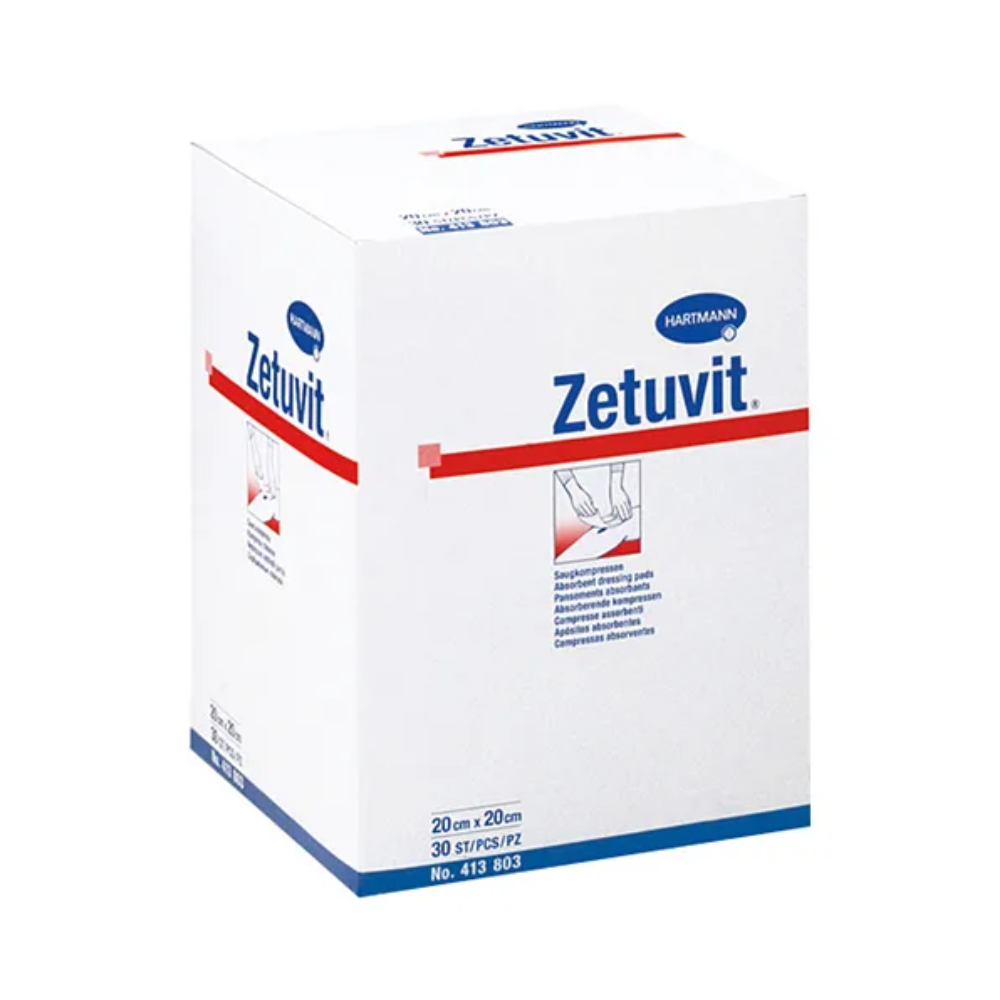 A white box with non-sterile Hartmann Zetuvit absorbent compresses from Paul Hartmann AG with blue-red brand printing. The box features text and images illustrating the absorbent compress.