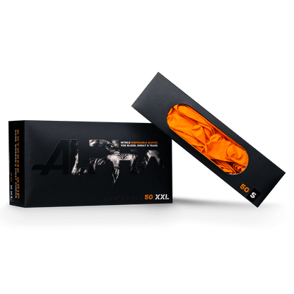 A black ALPHA box from AMPri Handelsgesellschaft mbH contains 50 XXL High Grip nitrile disposable gloves in orange. The opened packaging reveals the bright orange gloves, partially visible through a transparent window.