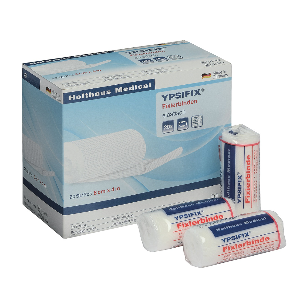 Íomhá de bhosca Holthaus Ypsifix® Bindeán Ceangail ó Holthaus Medical GmbH & Co. KG, 8 cm x 4 m. Tá 20 bindeán aonair sa bhosca. Tá trí bindeán aonair le feiceáil ar aghaidh an bhosca; tá dhá cheann fillte i bplaisteach, agus tá ceann amháin páirteach díphacáilte. Déanta sa Ghearmáin, foirfe chun clúdaigh créachta a dhaingniú.