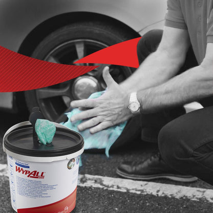 A person kneels to clean car wheels with green WypAll® wipes from Kimberly-Clark GmbH. In the foreground is a visible container with 6 buckets x 90 sheets. The black and white background features a bold red graphic accent.
