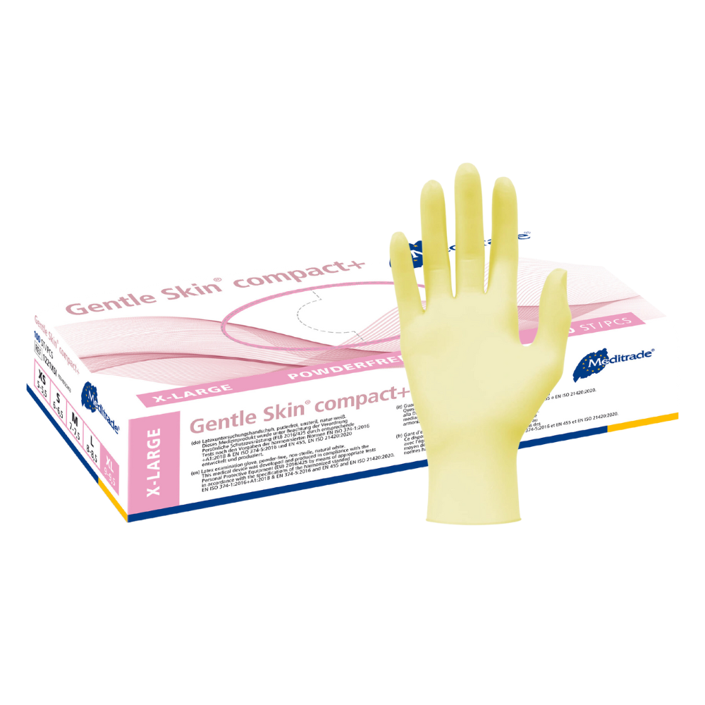 A yellow latex glove is seen in front of a background with a box of Meditrade Gentle Skin® Latex Gloves compact+ disposable gloves with the inscription 'powder-free' for food processing. The box is partially open, revealing more gloves from Meditrade GmbH.