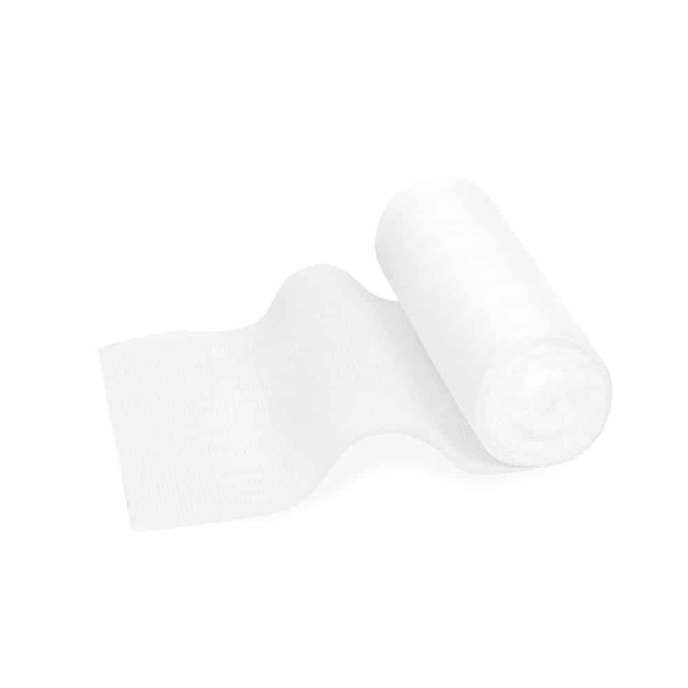 A roll of Meditrade ABE® Last elastic fixation bandage – various sizes, partially unrolled, lying on a plain white background. The paper is soft and has an elastic fixation bandage texture.