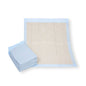 Next to an open pad, there is a stack of Meditrade bed protection pads 60 x 90 cm made from environmentally friendly recycled cellulose. With their rectangular design featuring a blue border and beige center, these pads from Meditrade GmbH offer hygiene or protection.