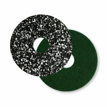 Two round Arcora PU-PAD floor buffers from Arcora International GmbH - one black with white speckles, one green, both with a center hole - overlap on a white background, perfect for your floor polishing machine.