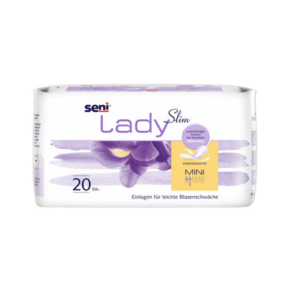 A 20-pack of Seni Lady Slim Mini a20 from TZMO Deutschland GmbH with violet iris design and German text offers light protection for bladder weakness with Extra Dry System for breathability and absorbency.