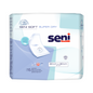 A pack of Seni Soft Super Dry bed protection pads from TZMO Deutschland GmbH in blue and white design contains 15 disposable pads (90 x 60 cm) with product branding and important features on the front.