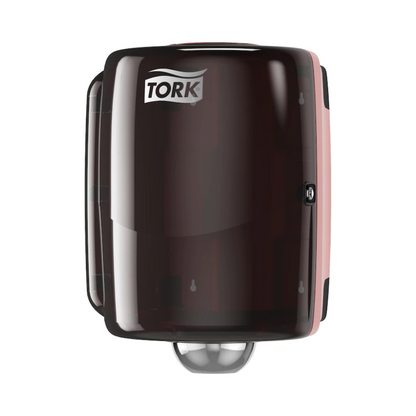 An elegant, black Tork 653008 Maxi Centerfeed Dispenser Performance W2 from Essity Professional Hygiene Germany GmbH is mounted against a white background. This dispenser in the performance design stands out with a rounded shape that showcases the visible roll inside and features a small opening at the bottom for easy dispensing.